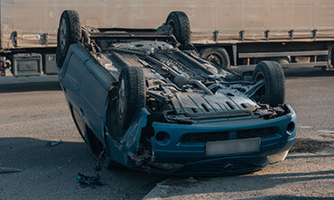 Overturned car accident scene on a highway – legal representation for traffic accident claims